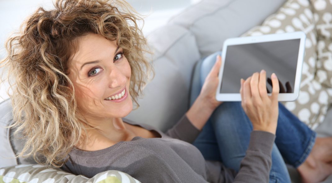 Back view of woman using digital tablet