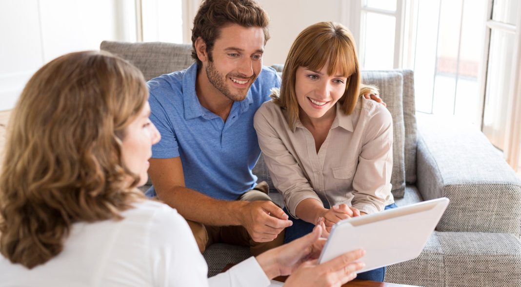 Real-estate agent presenting a new project property on digital tablet
